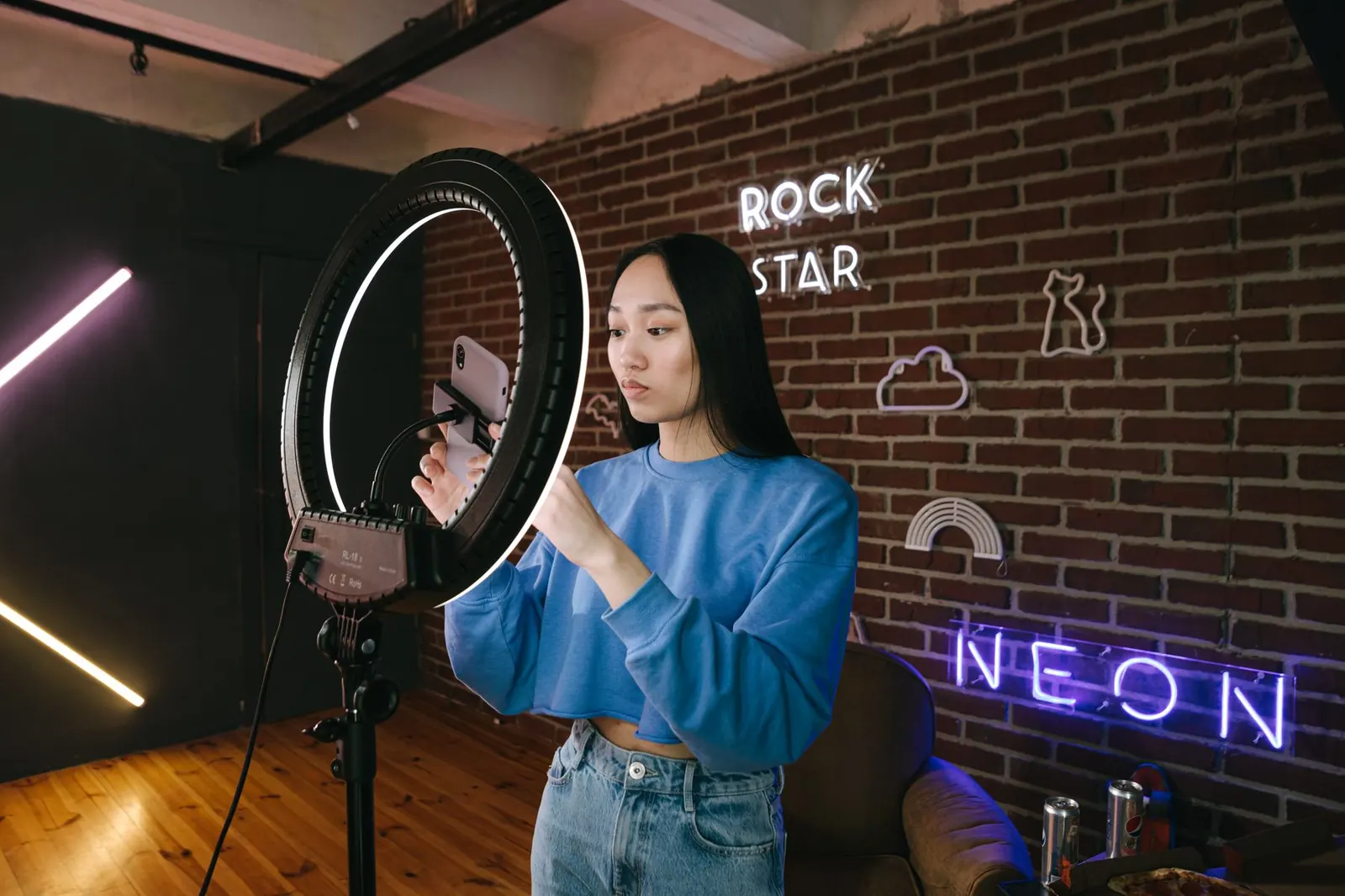 Woman filming a reel with a phone and ring light